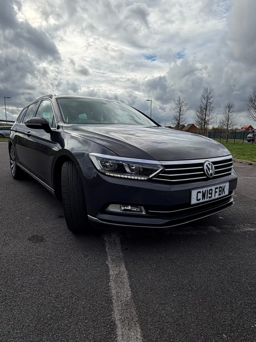 Dark grey estate car on a cloudy day